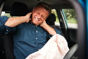 man with neck pain after a car accident